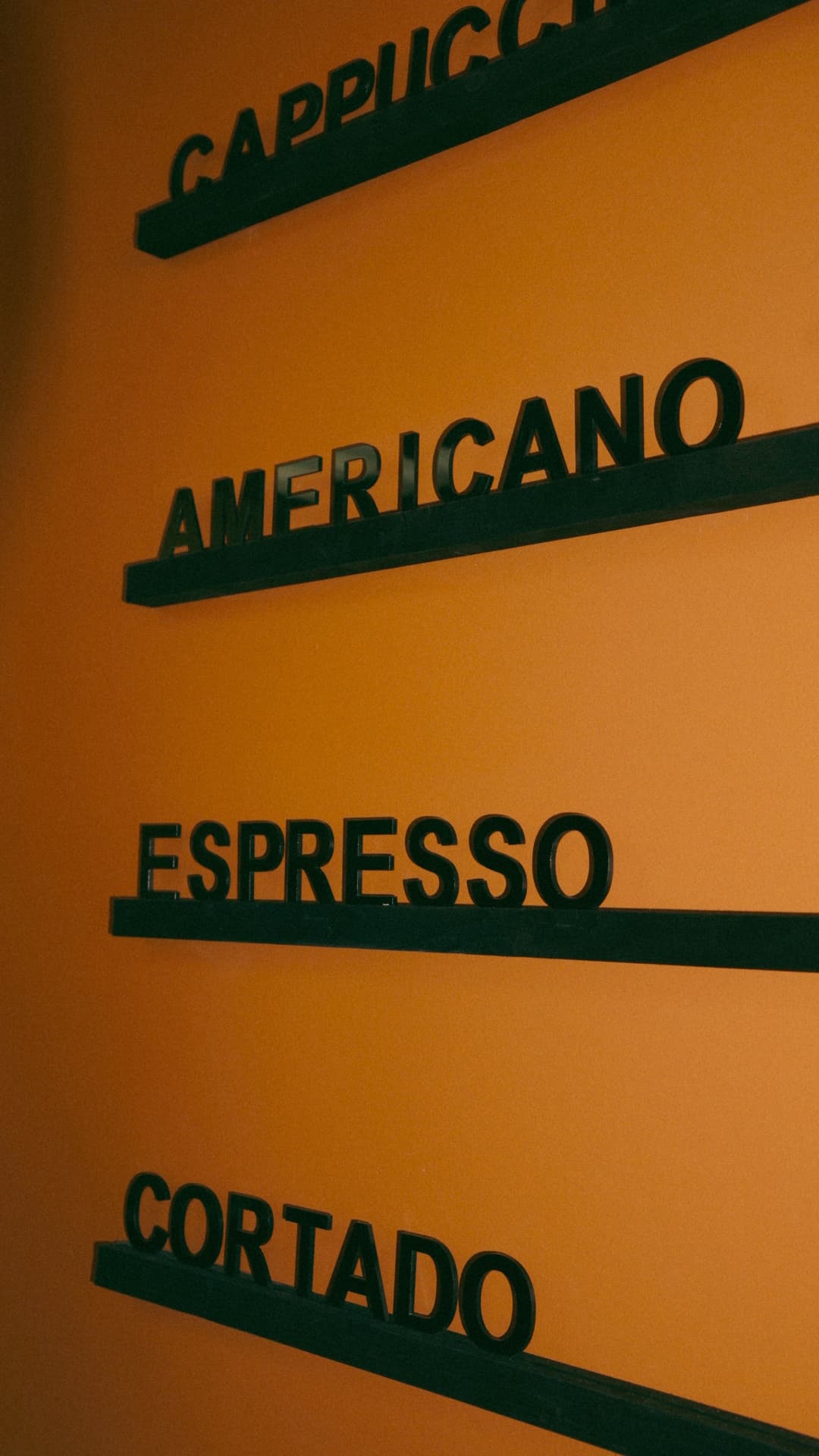 Revival Coffee menu board showing Cappuccino, Americano, Espresso, Cortado